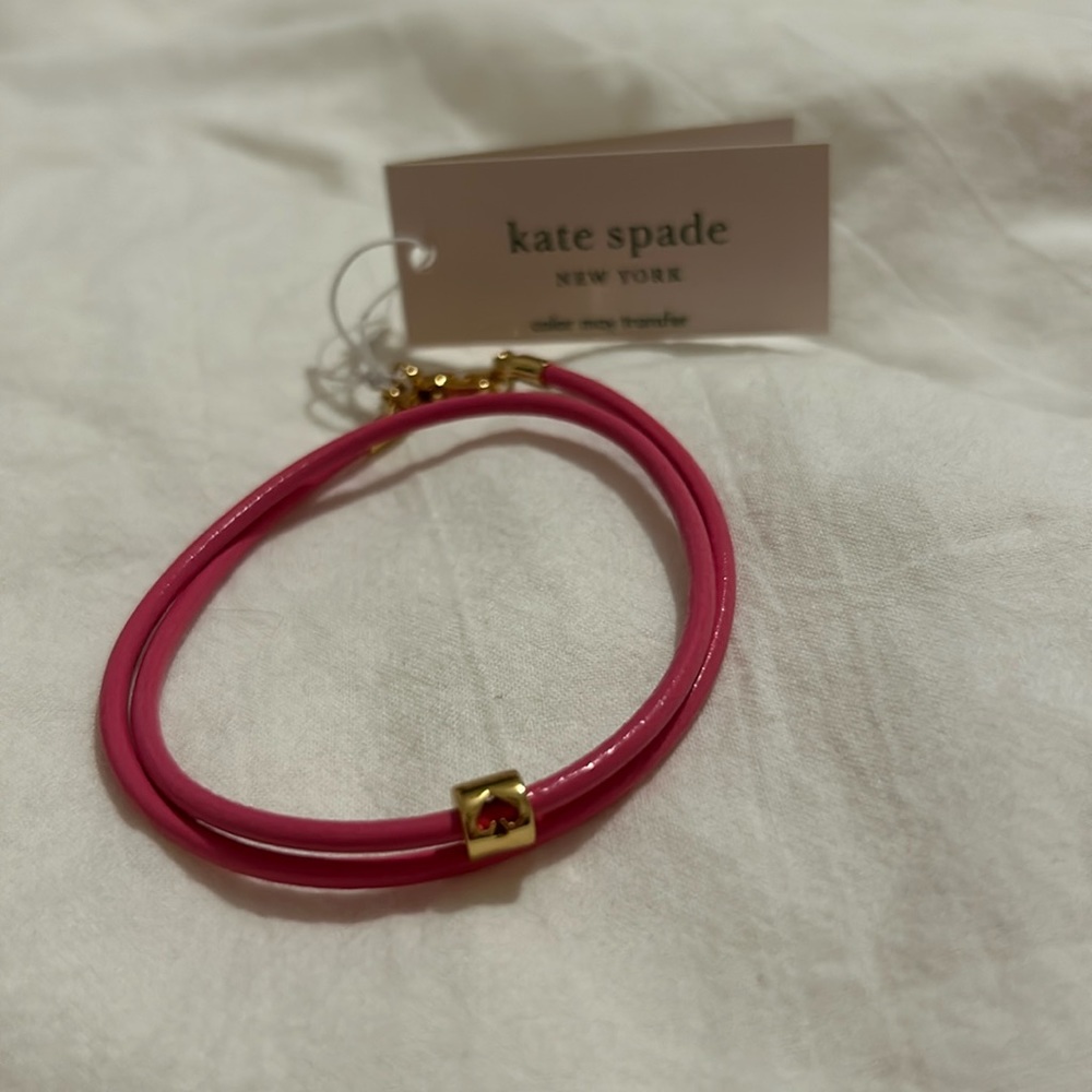 NWT pink leather cord wrap style Kate Spade bracelet with gold Kate Spade logo
